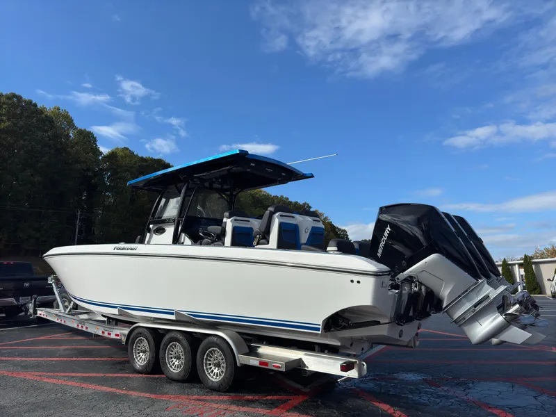 Slide: The Image of 2024 Fountain 34 SC boat on trailer under blue sky. - 3