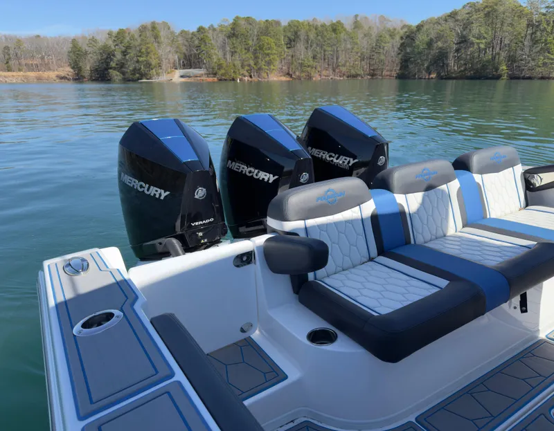 Slide: The Image of 2024 Fountain 34 SC boat with triple Mercury engines on a serene lake. - 6