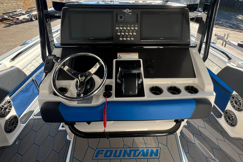 Slide: The Image of 2024 Fountain 34 SC boat dashboard with steering wheel and control panel. - 8