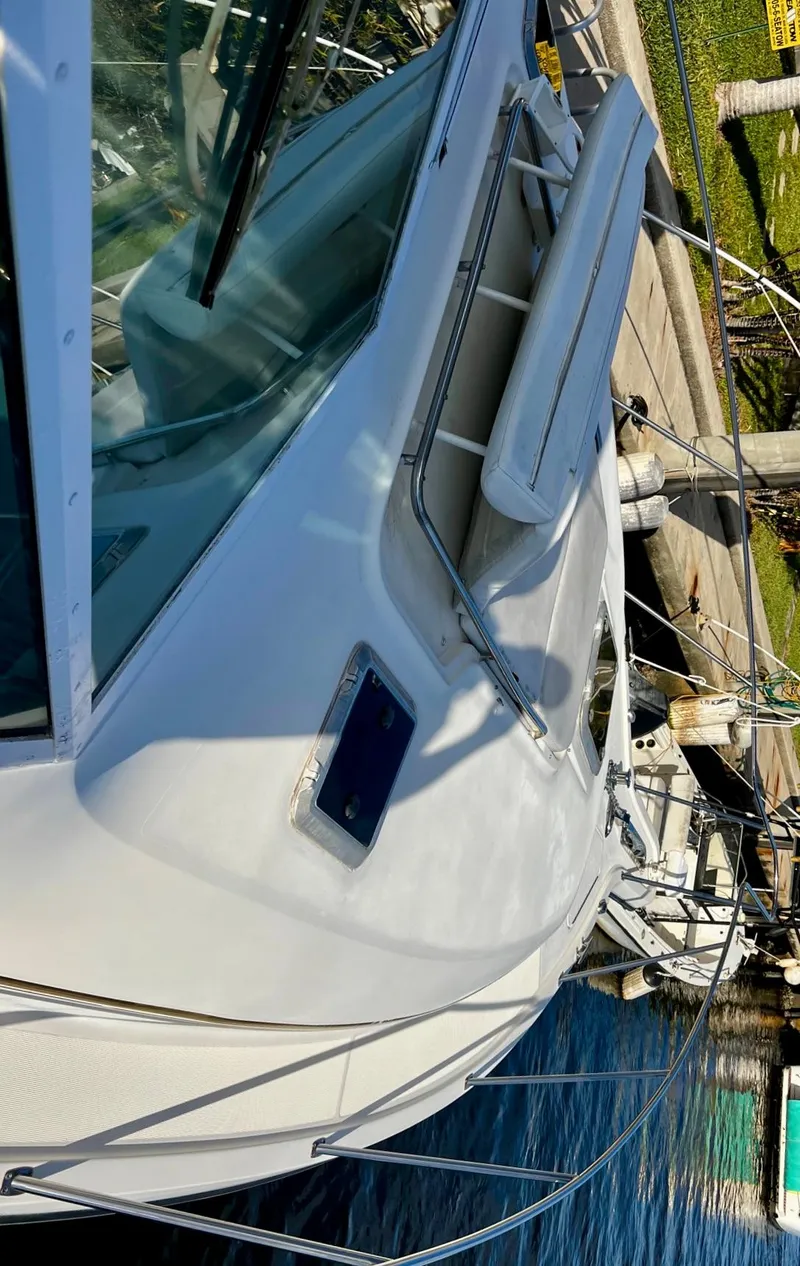 Slide: The Image of 1996 Tiara Yachts 3500 Express docked at a marina. - 15