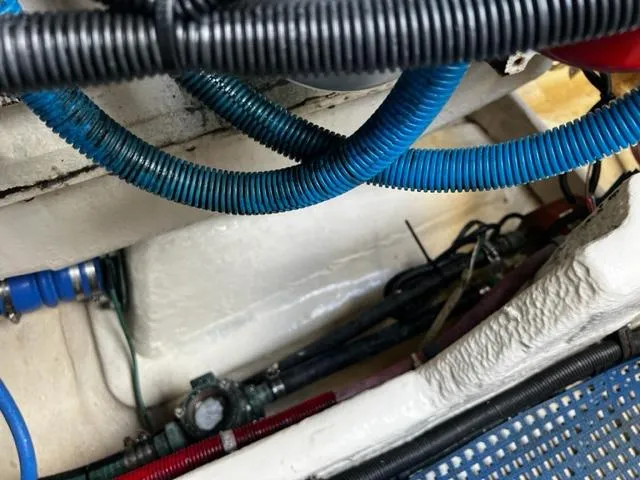Slide: The Image of Engine compartment of a 1996 Tiara Yachts 3500 Express with blue and black hoses. - 16