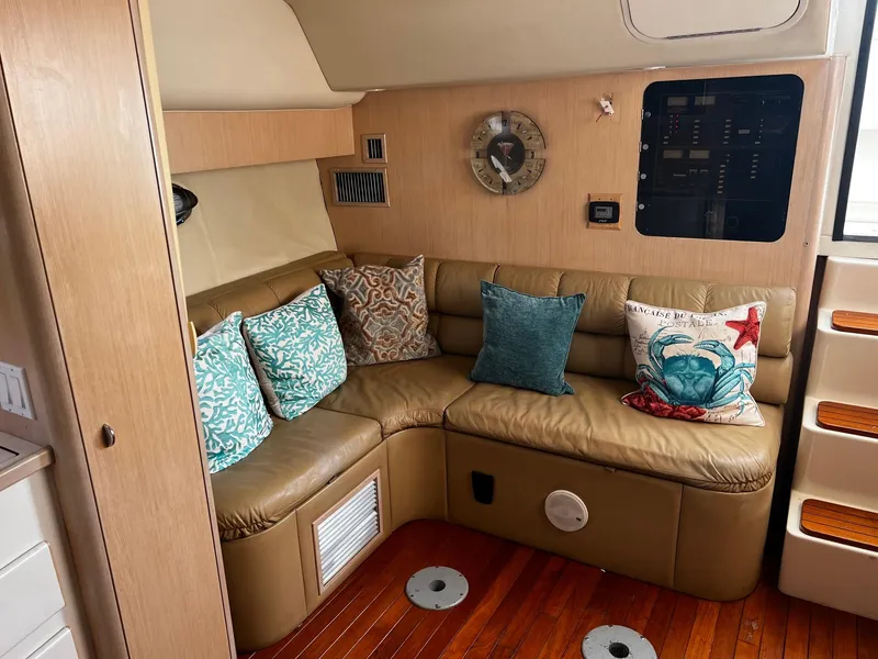 Slide: The Image of 1996 Tiara Yachts 3500 Express interior with leather seating and decorative pillows. - 21