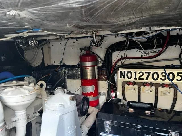 Slide: The Image of Engine room of a 1996 Tiara Yachts 3500 Express with fire extinguisher and wiring. - 26