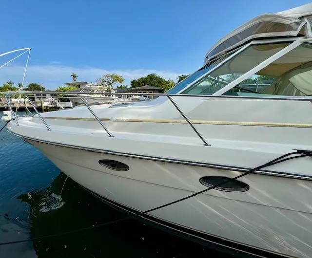 Slide: The Image of 1996 Tiara Yachts 3500 Express docked in a marina. - 3