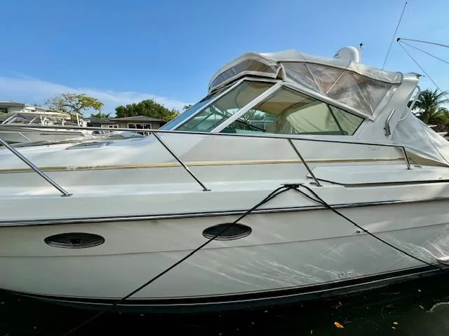 Slide: The Image of 1996 Tiara Yachts 3500 Express boat docked in a marina. - 4