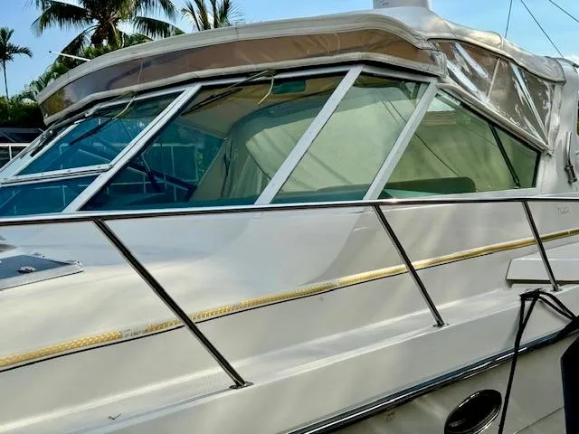 Slide: The Image of 1996 Tiara Yachts 3500 Express boat with white exterior and large windows. - 6