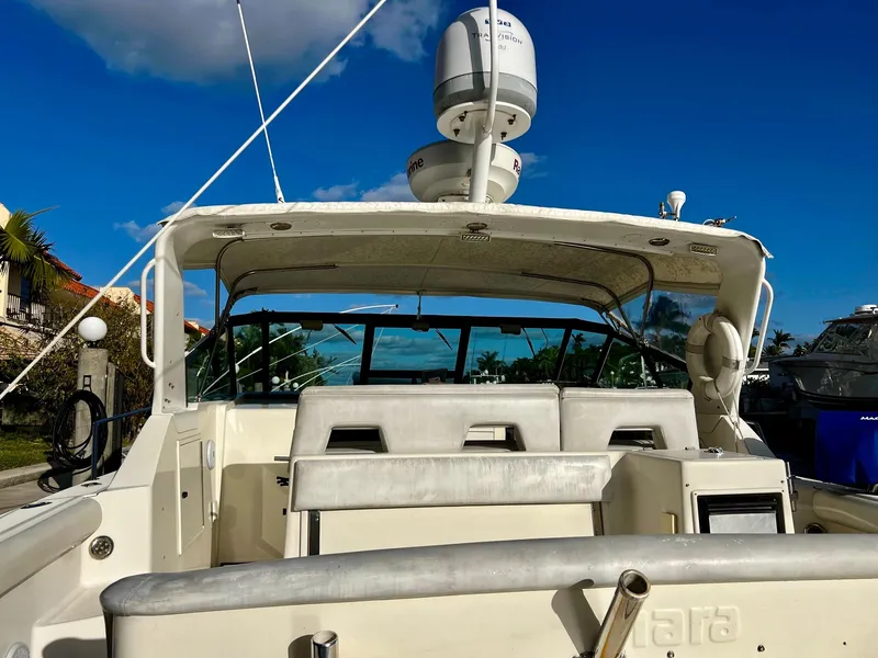 Slide: The Image of 1996 Tiara Yachts 3500 Express boat with white seating and radar equipment. - 7