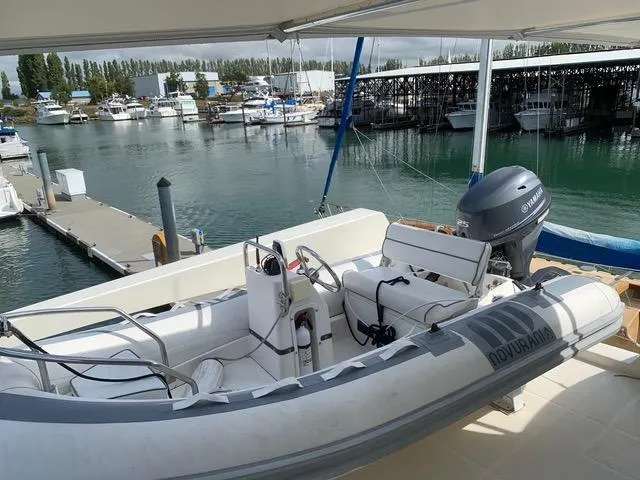 Slide: The Image of 2008 Hampton Command Bridge yacht with inflatable boat at marina. - 12