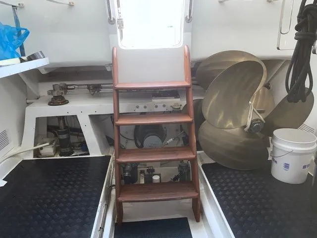 Slide: The Image of Engine room of a 2008 Hampton Command Bridge yacht with wooden steps and large propellers. - 14