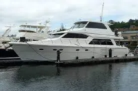 Slide: The Image of 2008 Hampton Command Bridge yacht docked at a marina. - 2
