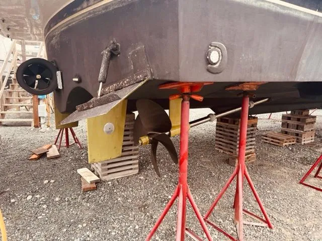 Slide: The Image of 2008 Hampton Command Bridge boat on stands, showing propeller and rudder. - 20