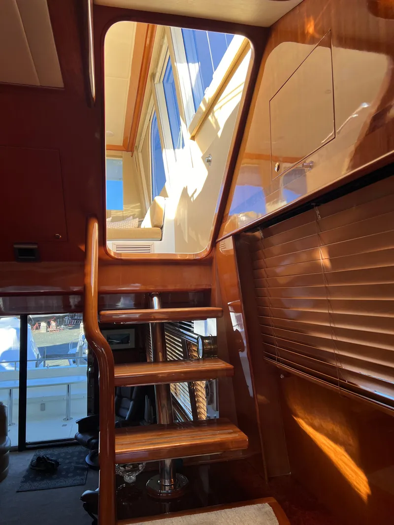 Slide: The Image of Interior stairs of a 2008 Hampton Command Bridge yacht with wooden finish. - 22