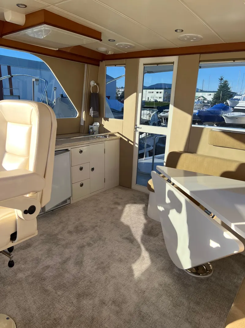 Slide: The Image of Interior of 2008 Hampton Command Bridge yacht with beige seating and carpet. - 28