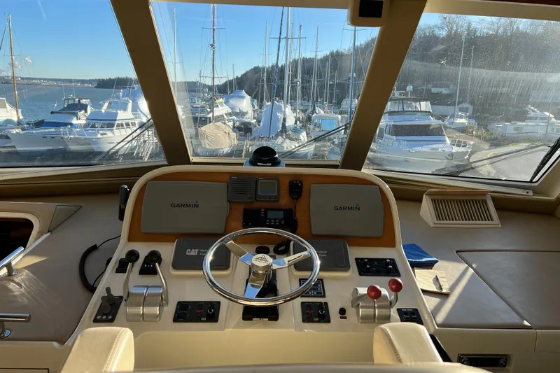 Slide: The Image of 2008 Hampton Command Bridge yacht helm with Garmin navigation, overlooking marina. - 32