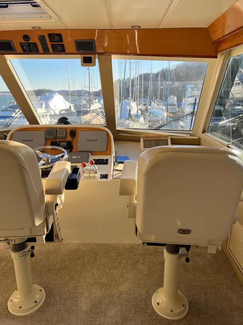 Slide: The Image of Interior helm of a 2008 Hampton Command Bridge yacht with dual captain chairs. - 35