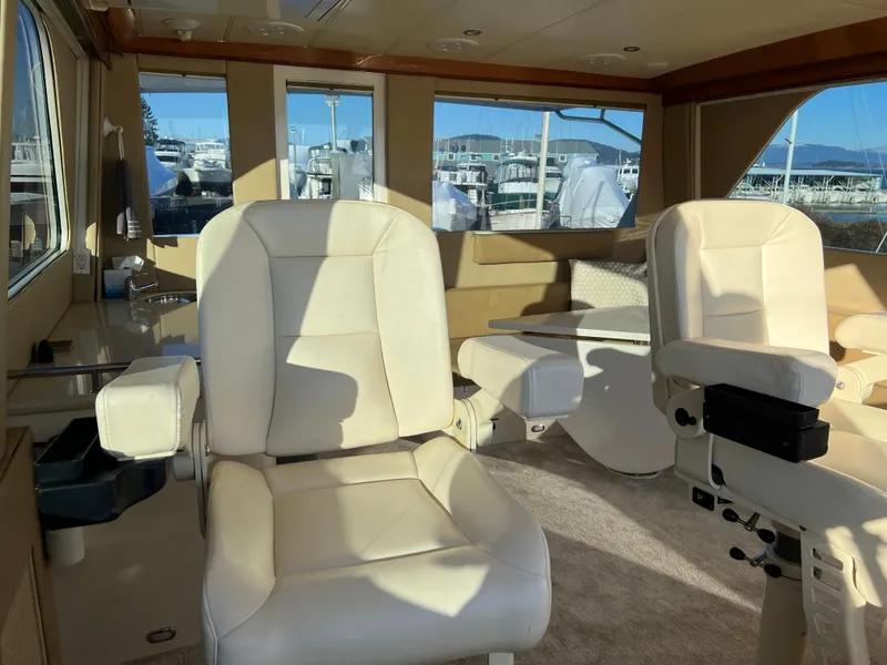 Slide: The Image of Interior of a 2008 Hampton Command Bridge yacht with white leather seats. - 37