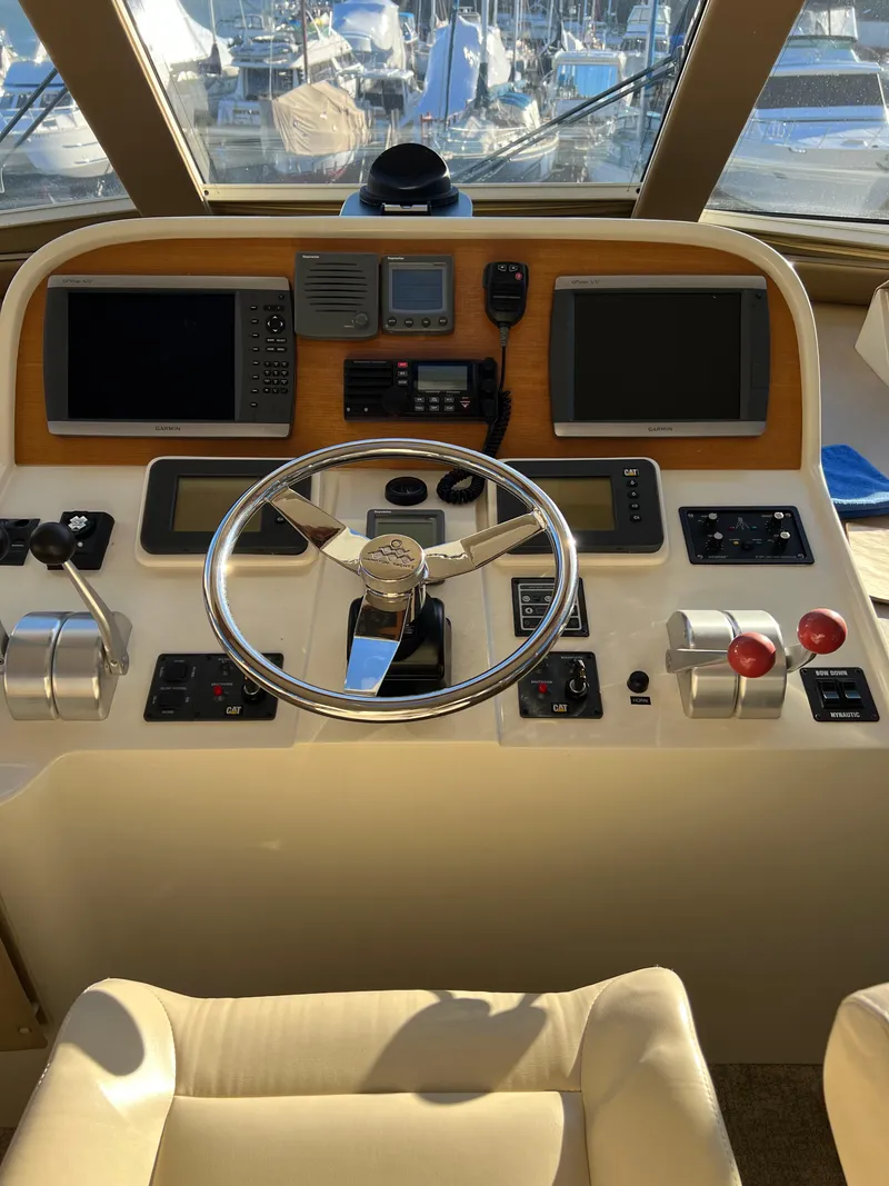 Slide: The Image of 2008 Hampton Command Bridge yacht helm with modern navigation equipment and controls. - 38