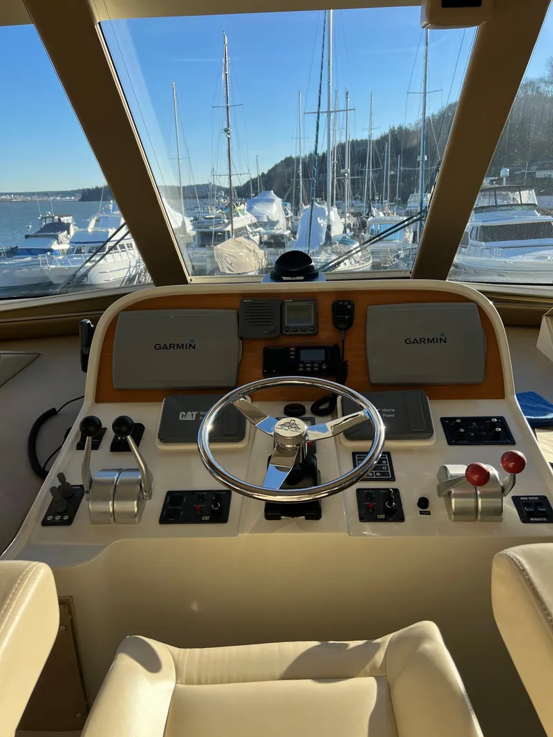 Slide: The Image of 2008 Hampton Command Bridge yacht helm with Garmin navigation, docked at a marina. - 40