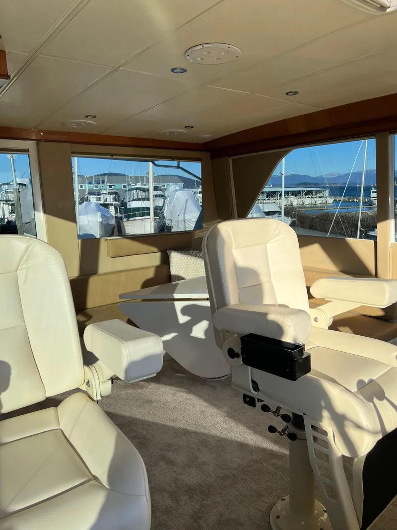 Slide: The Image of Interior of 2008 Hampton Command Bridge yacht with white leather seating. - 43