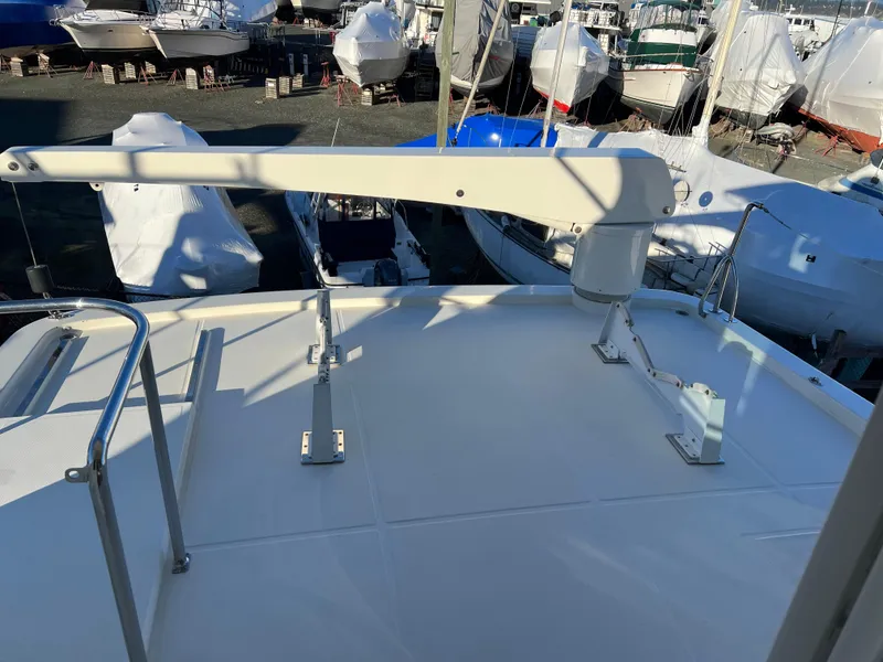 Slide: The Image of 2008 Hampton Command Bridge yacht deck with marina background. - 44