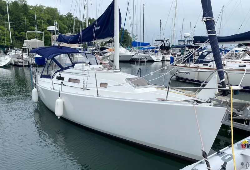 The Image of 2001 J Boats 32 sailboat docked in a marina, surrounded by other vessels. - 0