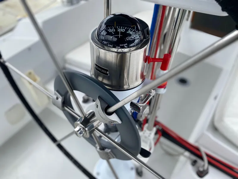 Slide: The Image of Steering wheel and compass on a 2001 J Boats 32 sailboat. - 13