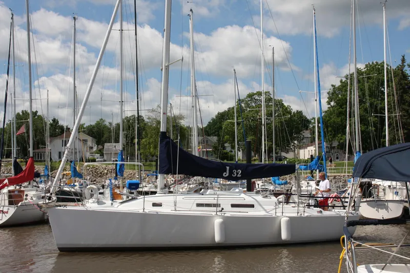 Slide: The Image of 2001 J Boats 32 sailboat docked in a marina with other vessels. - 14