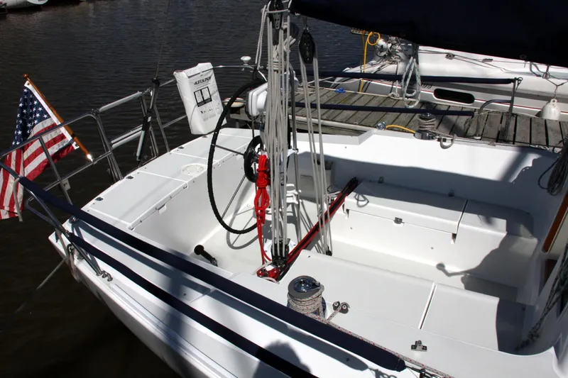 Slide: The Image of 2001 J Boats 32 sailboat cockpit with American flag, docked at marina. - 19