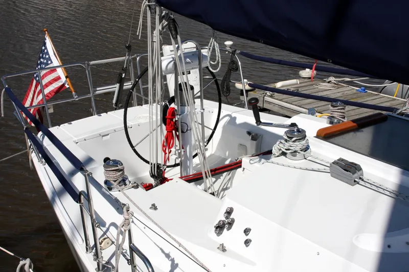 Slide: The Image of 2001 J Boats 32 sailboat cockpit with American flag, docked in marina. - 20