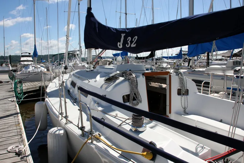 Slide: The Image of 2001 J Boats 32 sailboat docked at marina under clear blue sky. - 21