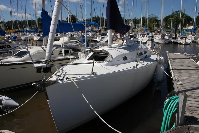 Slide: The Image of 2001 J Boats 32 sailboat docked in a marina, surrounded by other vessels. - 25