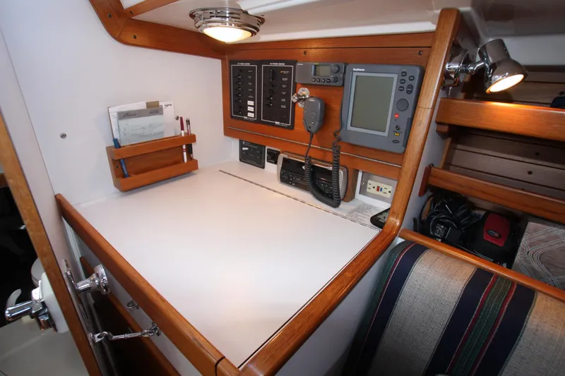 Slide: The Image of Navigation station inside 2001 J Boats 32 sailboat, featuring control panels and communication equipment. - 29