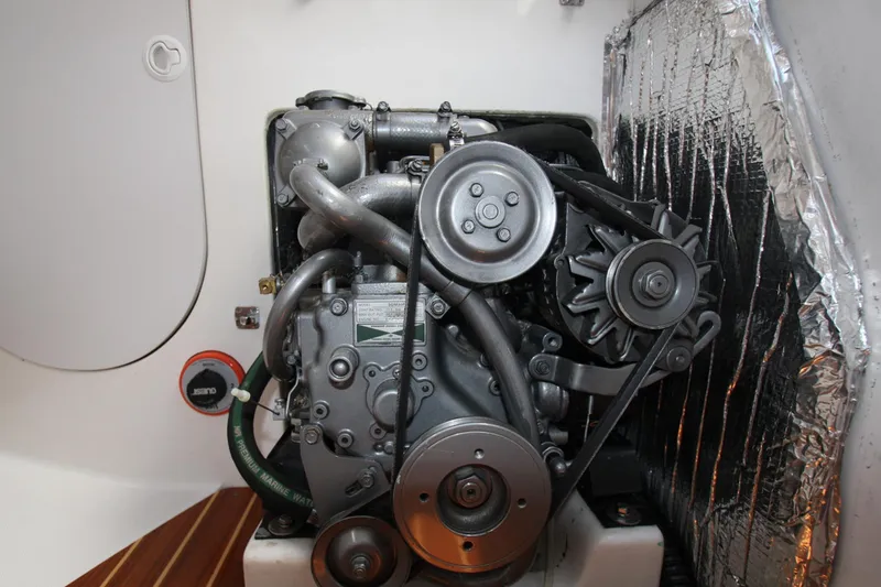 Slide: The Image of Engine compartment of a 2001 J Boats 32 sailboat, featuring a compact marine engine. - 34