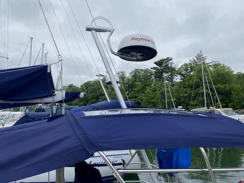 Slide: The Image of Sailboat with blue canopy and Raymarine radar, J Boats 32, 2001 model, docked in marina. - 8