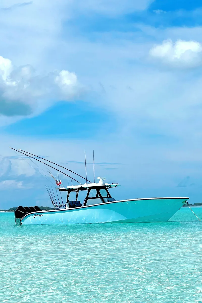 Slide: The Image of 2022 Yellowfin 39 boat on clear turquoise water under a blue sky. - 0