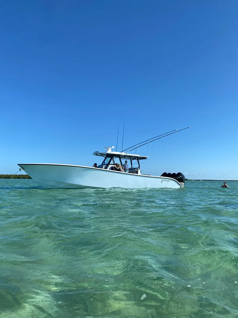 Slide: The Image of 2022 Yellowfin 39 boat on clear blue water under a sunny sky. - 1
