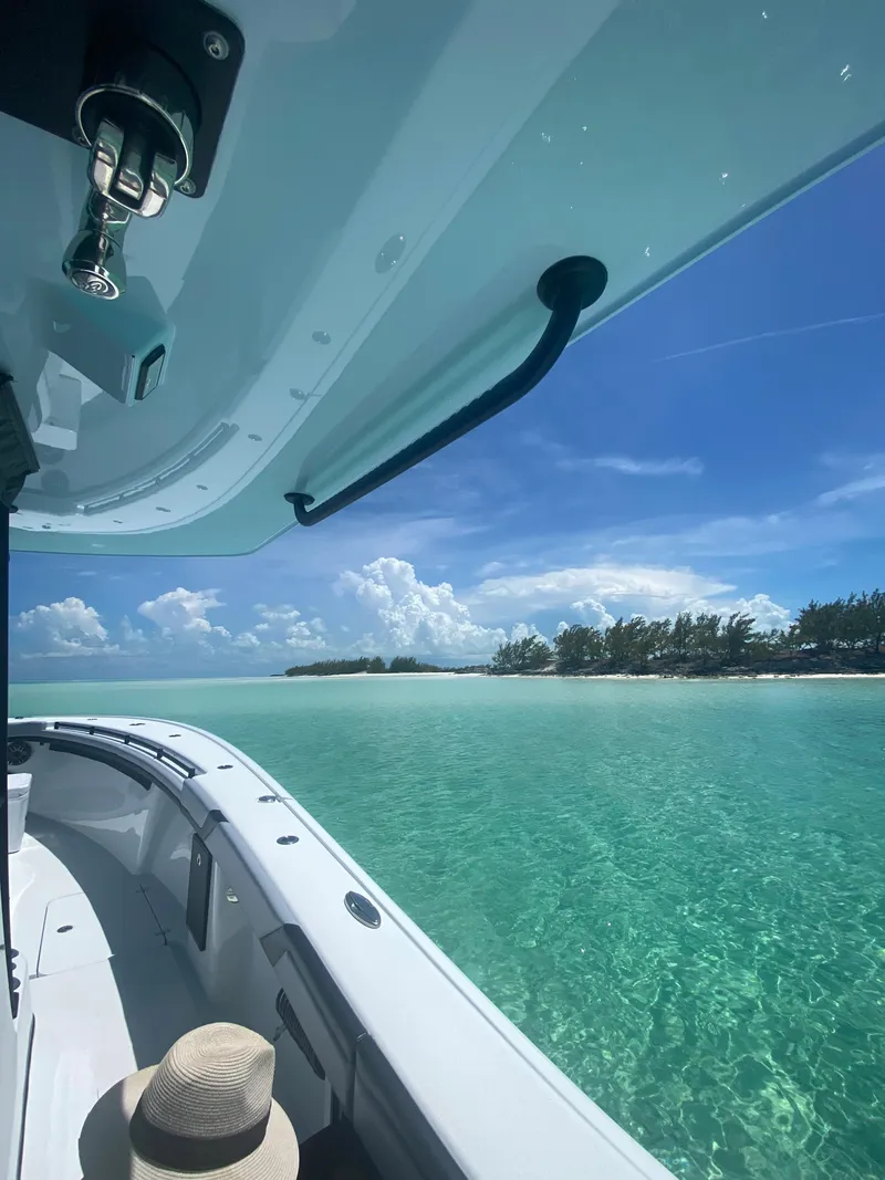 Slide: The Image of 2022 Yellowfin 39 boat cruising in clear turquoise waters near a tropical island. - 15