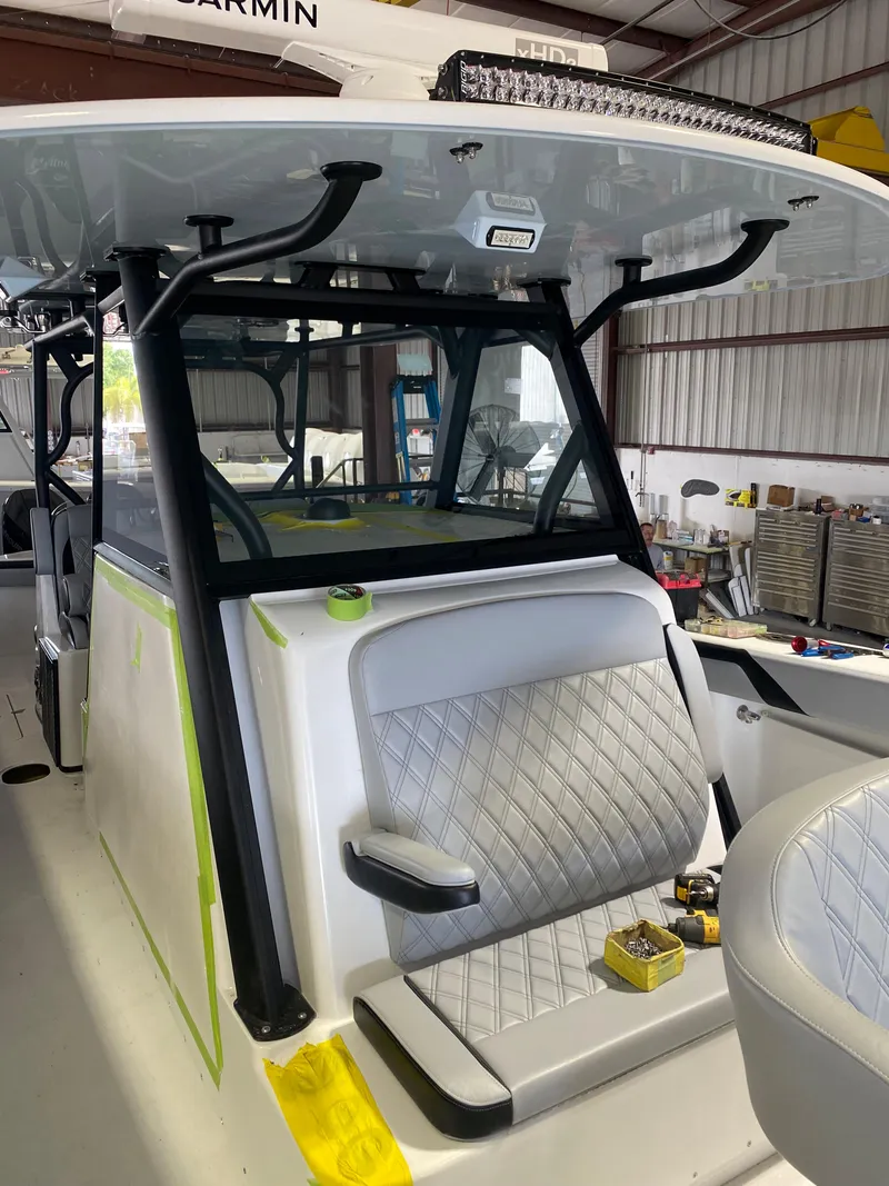 Slide: The Image of 2022 Yellowfin 39 boat interior with diamond-stitched seating in a workshop. - 18