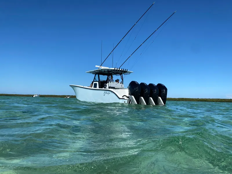 Slide: The Image of 2022 Yellowfin 39 boat with four outboard motors in clear water. - 2