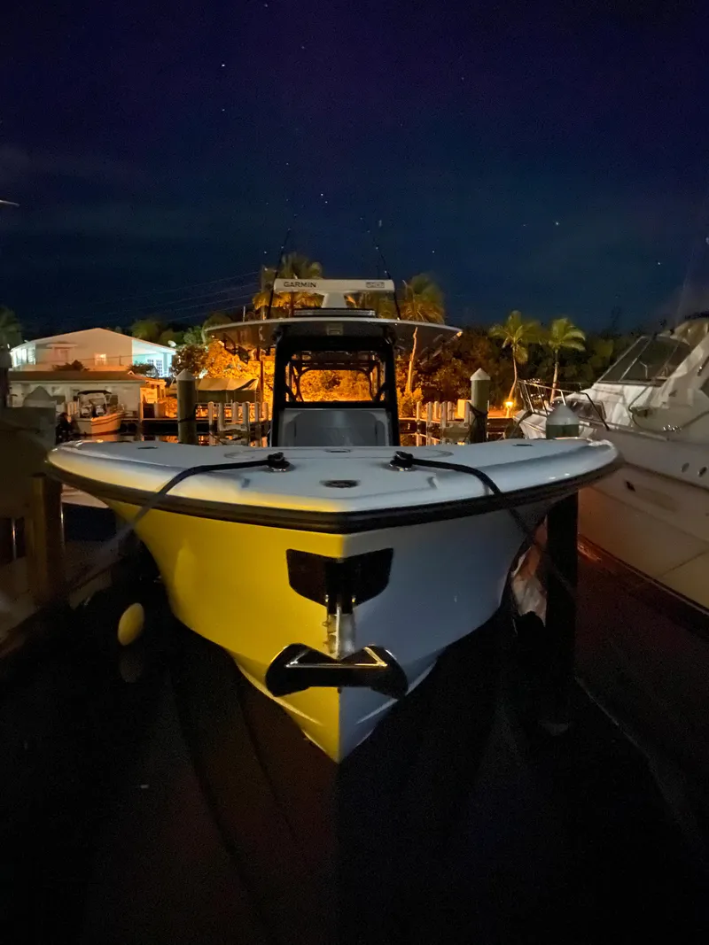 Slide: The Image of 2022 Yellowfin 39 boat docked at night with lights illuminating the surroundings. - 22