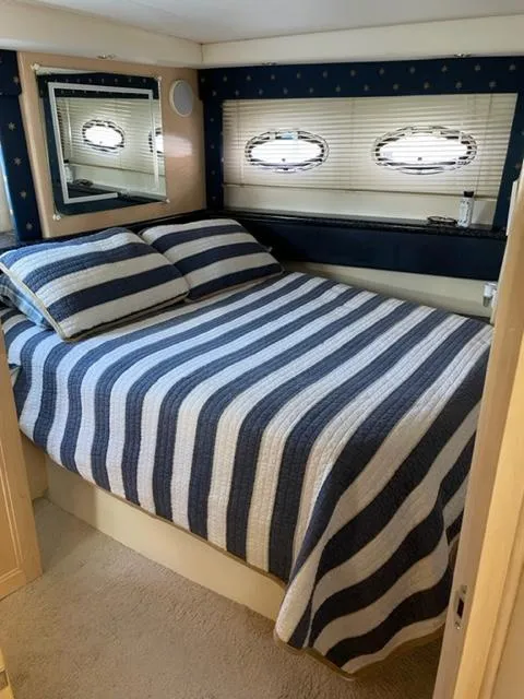 Slide: The Image of Interior of Carver 356 yacht with striped bedding. - 48