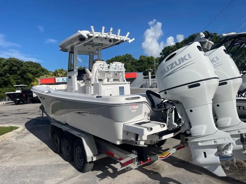 Slide: The Image of 2024 Blue Wave 2800 Makaira boat with twin Suzuki engines on trailer. - 3