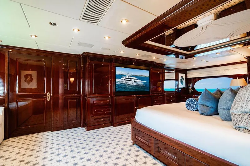 Slide: The Image of Luxurious 2008 Christensen Tri-Deck Motor Yacht bedroom with elegant wood finishes and plush bedding. - 13