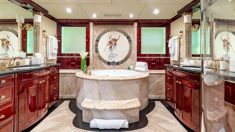 Slide: The Image of Luxurious yacht bathroom with marble tub, elegant wood cabinetry, and decorative wall art, 2008 Christensen model. - 26