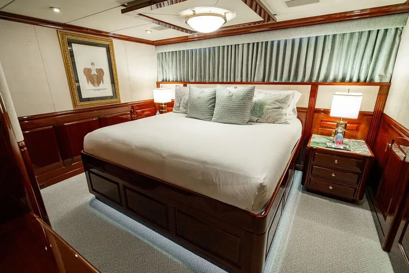 Slide: The Image of Luxurious bedroom on 2008 Christensen Tri-Deck Motor Yacht with elegant wood paneling and plush bedding. - 27