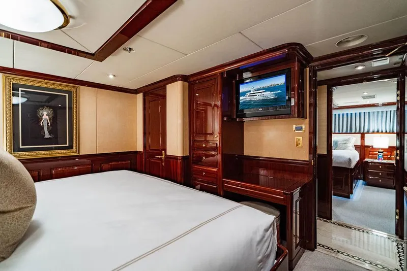 Slide: The Image of Luxurious bedroom interior on 2008 Christensen Tri-Deck Motor Yacht with elegant wood paneling. - 28