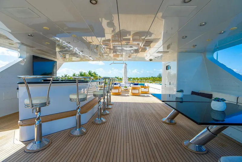 Slide: The Image of Luxurious 2008 Christensen Tri-Deck Motor Yacht with elegant outdoor bar and seating area. - 36