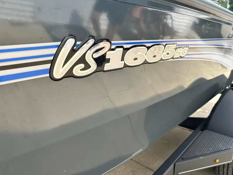 Slide: The Image of 2024 Ranger VS1665SC boat side view with model name and blue stripes. - 10