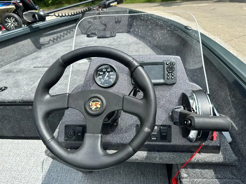 Slide: The Image of 2024 Ranger VS1665SC boat dashboard with steering wheel, speedometer, and navigation system. - 6