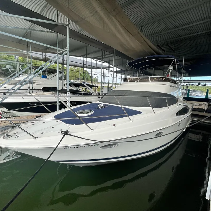 Slide: The Image of 2002 Regal Commodore 3880 yacht docked in a covered marina. - 1